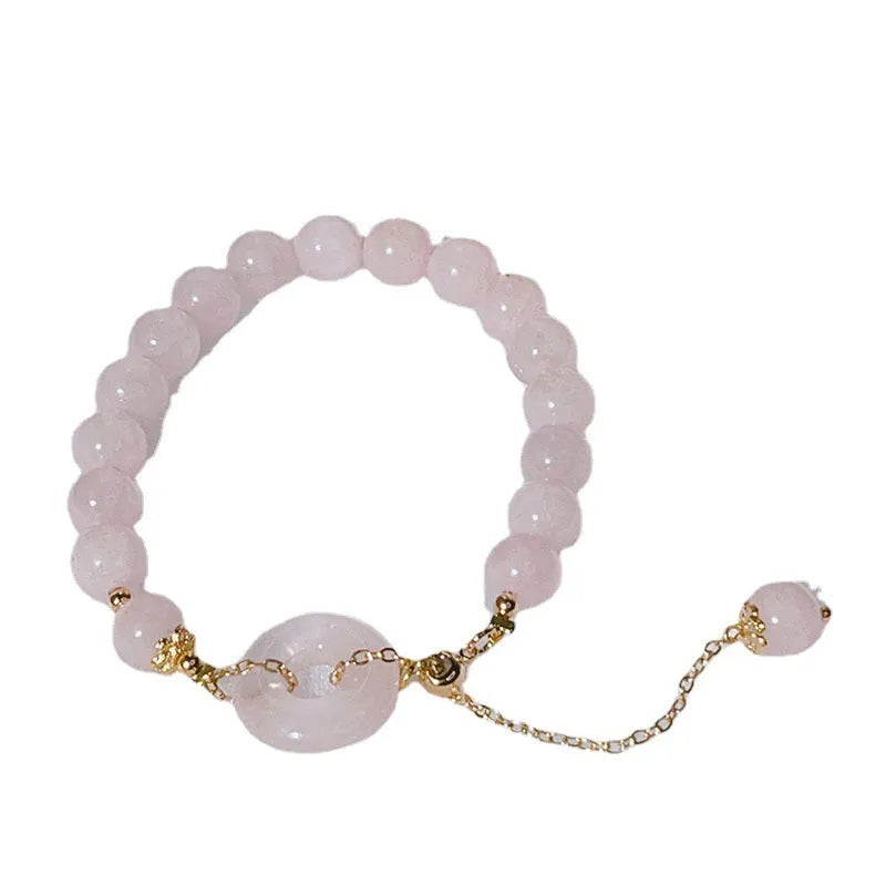 Pink crystal bracelet with peace symbol safety buckle clasp on woman's wrist