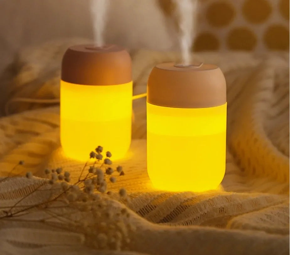 White cylindrical USB mini humidifier with charging cable