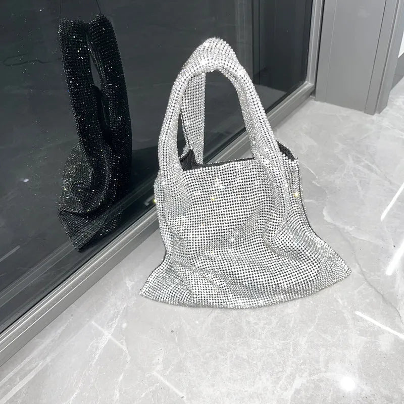 Silver handbag decorated with shiny rhinestones, made from cotton thread with one open pocket.