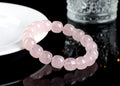 Pink crystal barrel bead bracelet with geometric design on a wrist.