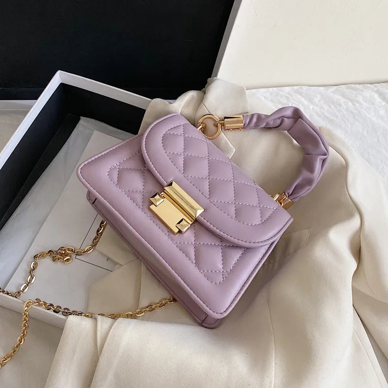 Purple rhombus-shaped small square ladies bag with chain-link shoulder strap on a white background