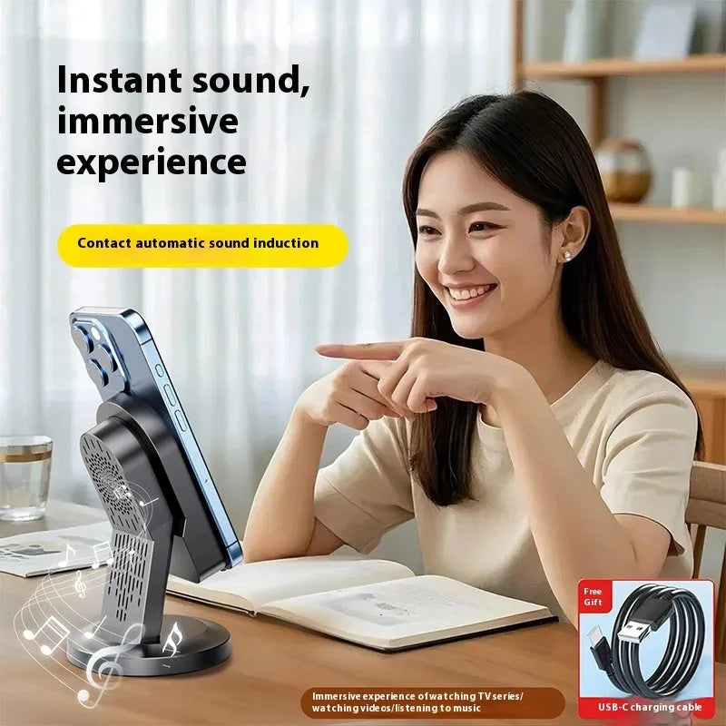 Three-in-one wireless induction speaker and Bluetooth phone bracket in black or white, with built-in battery and USB cable