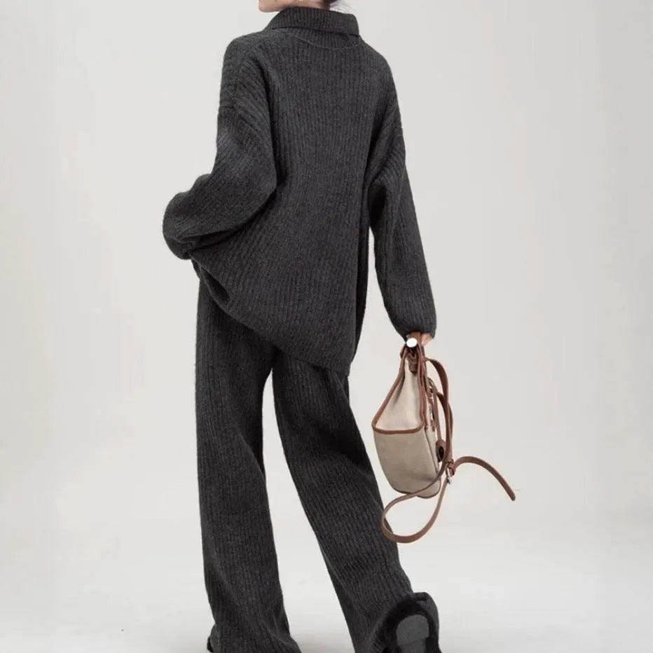 Woman wearing a beige acrylic knit sweater top and matching trousers from a casual two-piece set.