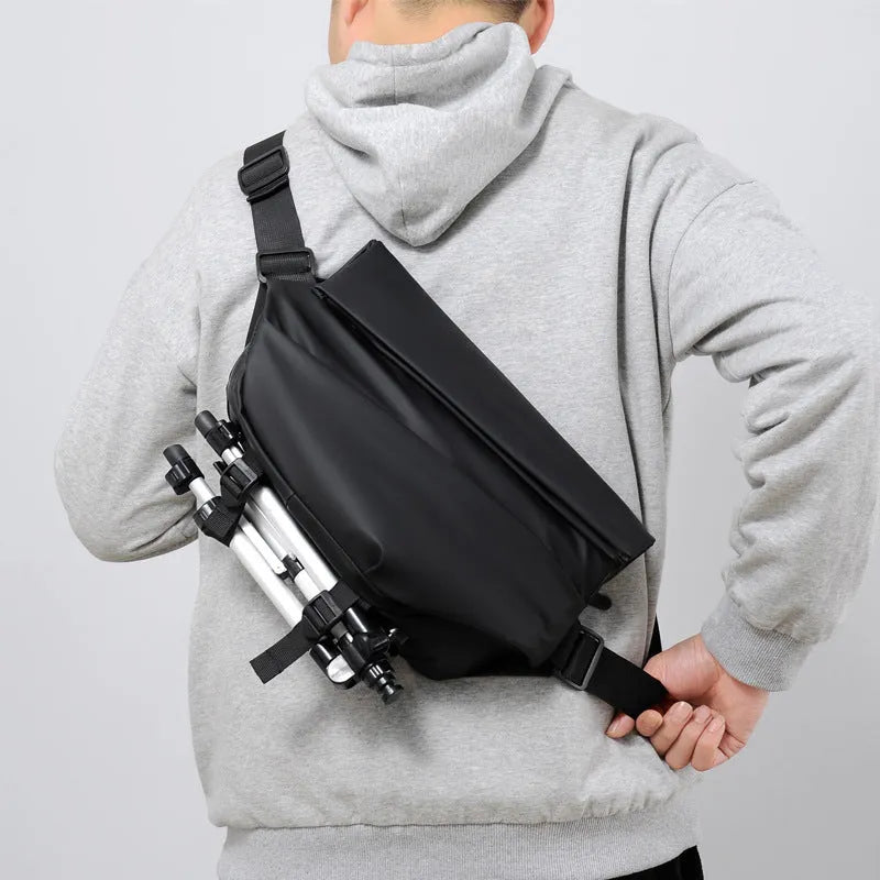 Grey men's crossbody sling bag made of PU leather with a zip opening and shoulder strap.