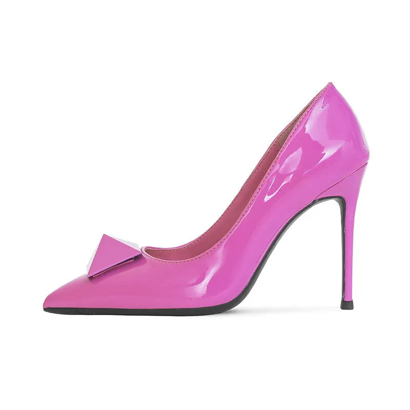 Pink women's patent leather pointed toe stiletto high heels with a buckle on the strap.