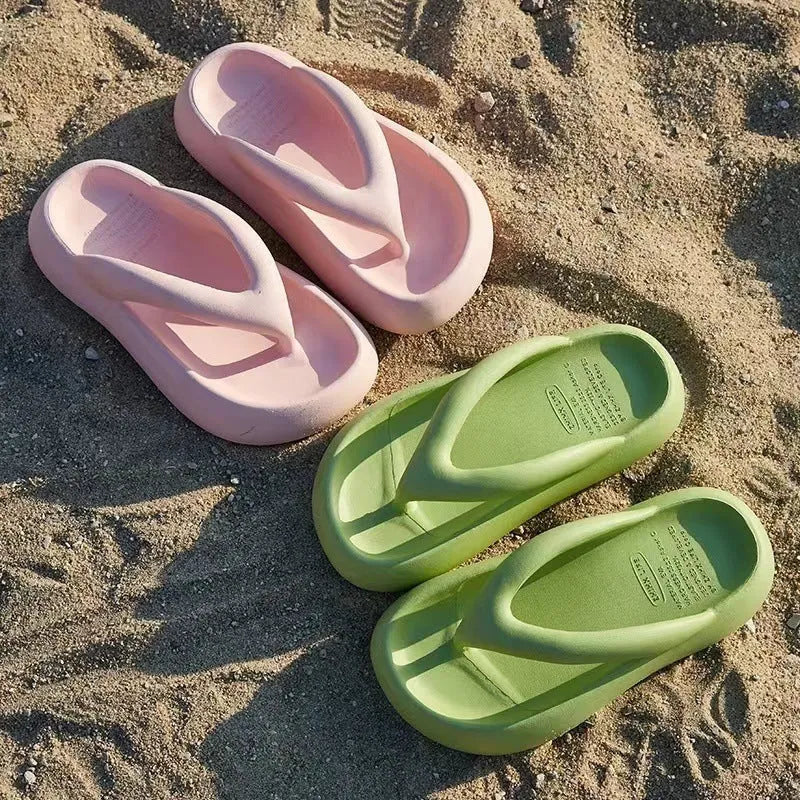 A pair of solid colour thick-soled EVA flip-flops with a bow detail on the strap.