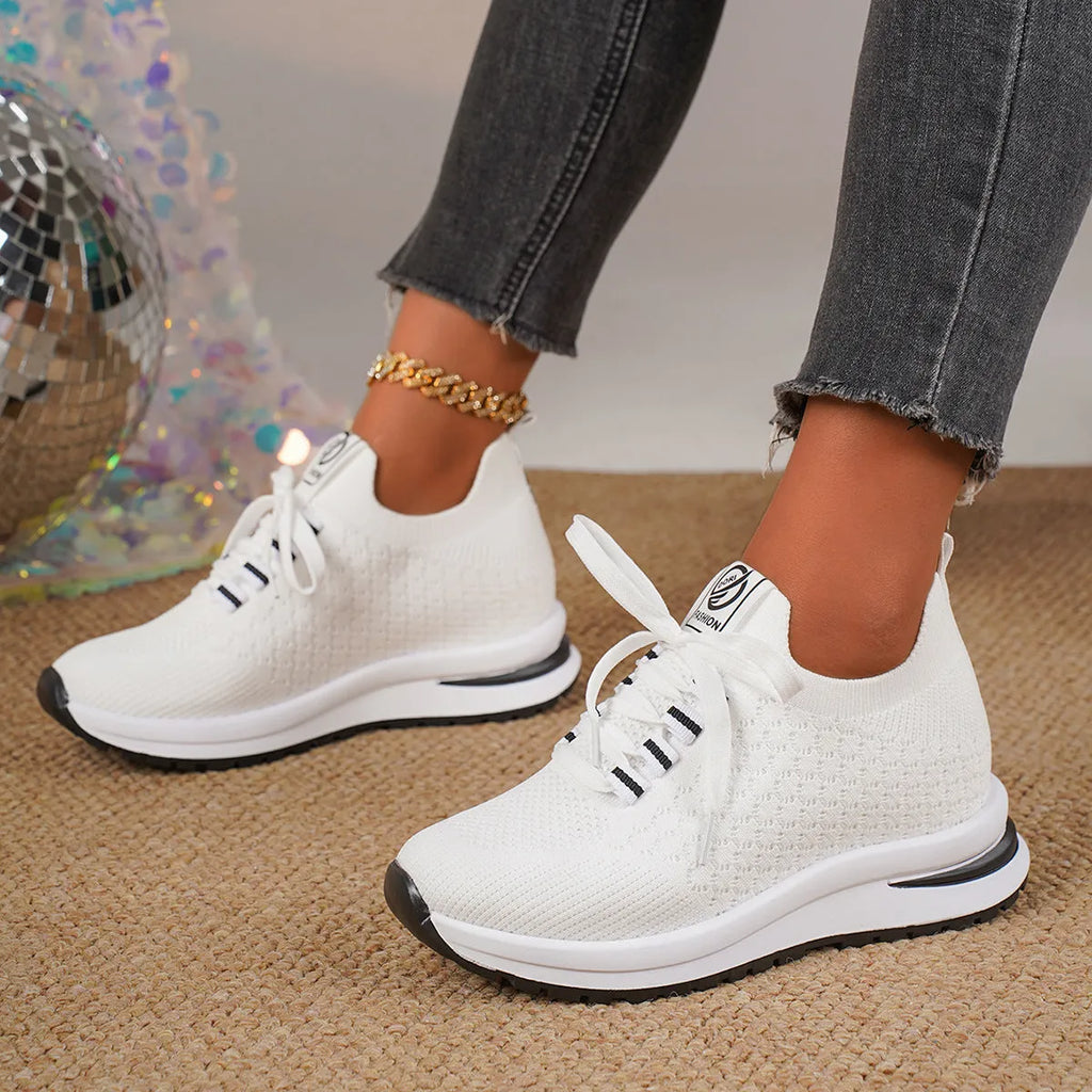 Women's black mesh lace-up flat platform sneaker on a white background