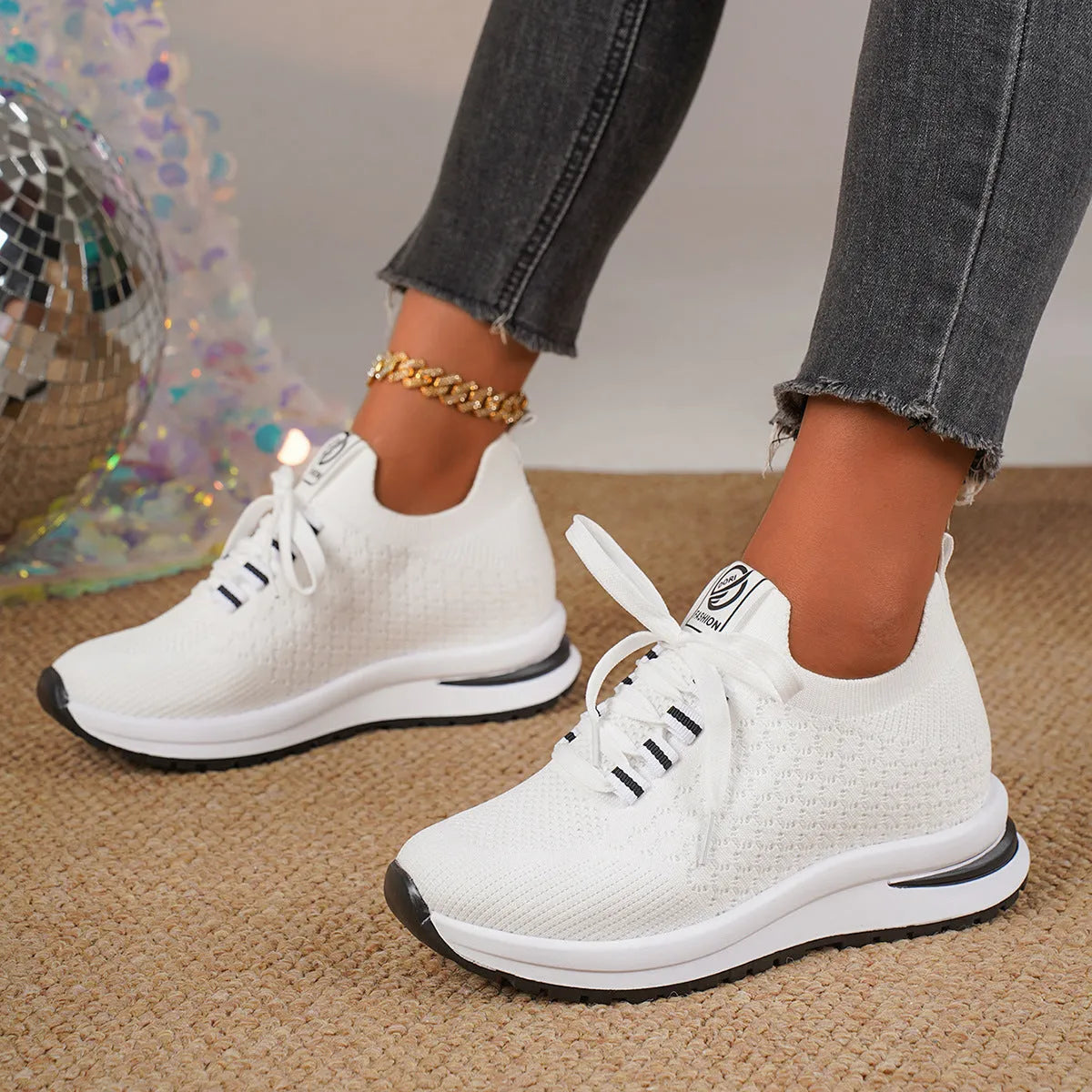 Women's black mesh lace-up flat platform sneaker on a white background