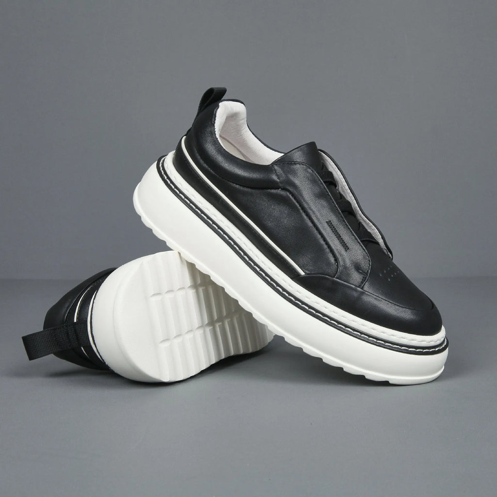 Women's black casual slip-on sneaker with cowhide upper, foam platform sole, round toe, and elastic band