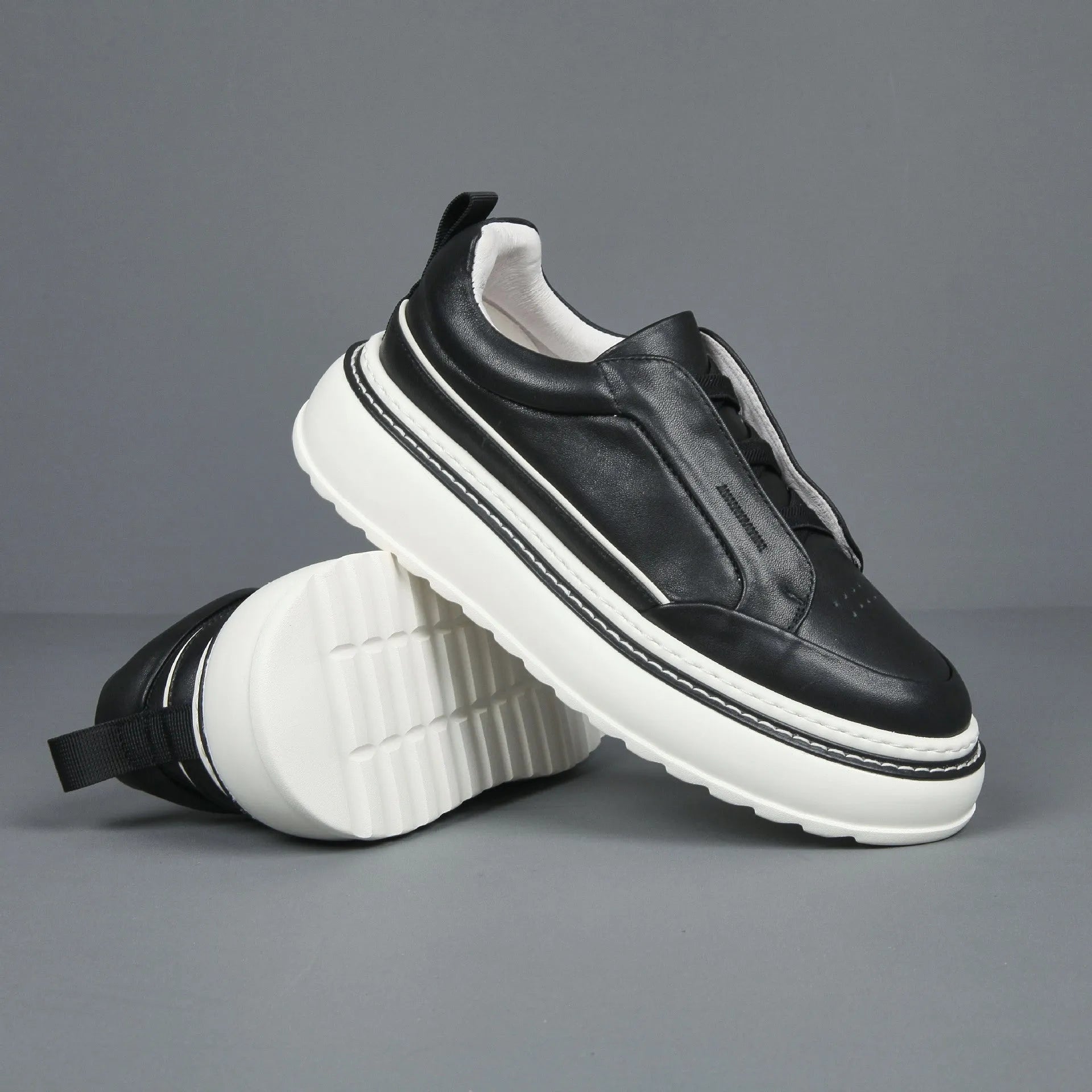 Women's black casual slip-on sneaker with cowhide upper, foam platform sole, round toe, and elastic band