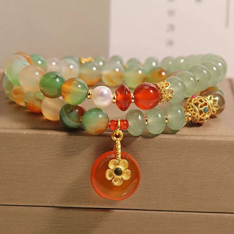 Peacock green agate double ring bracelet for women with safety buckle closure on wrist.