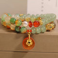 Peacock green agate double ring bracelet for women with safety buckle closure on wrist.