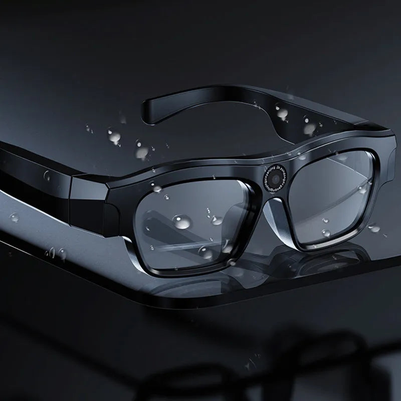 Black head-mounted smart Bluetooth glasses with a clear lens on a stand, showing the touch controls and recording camera.