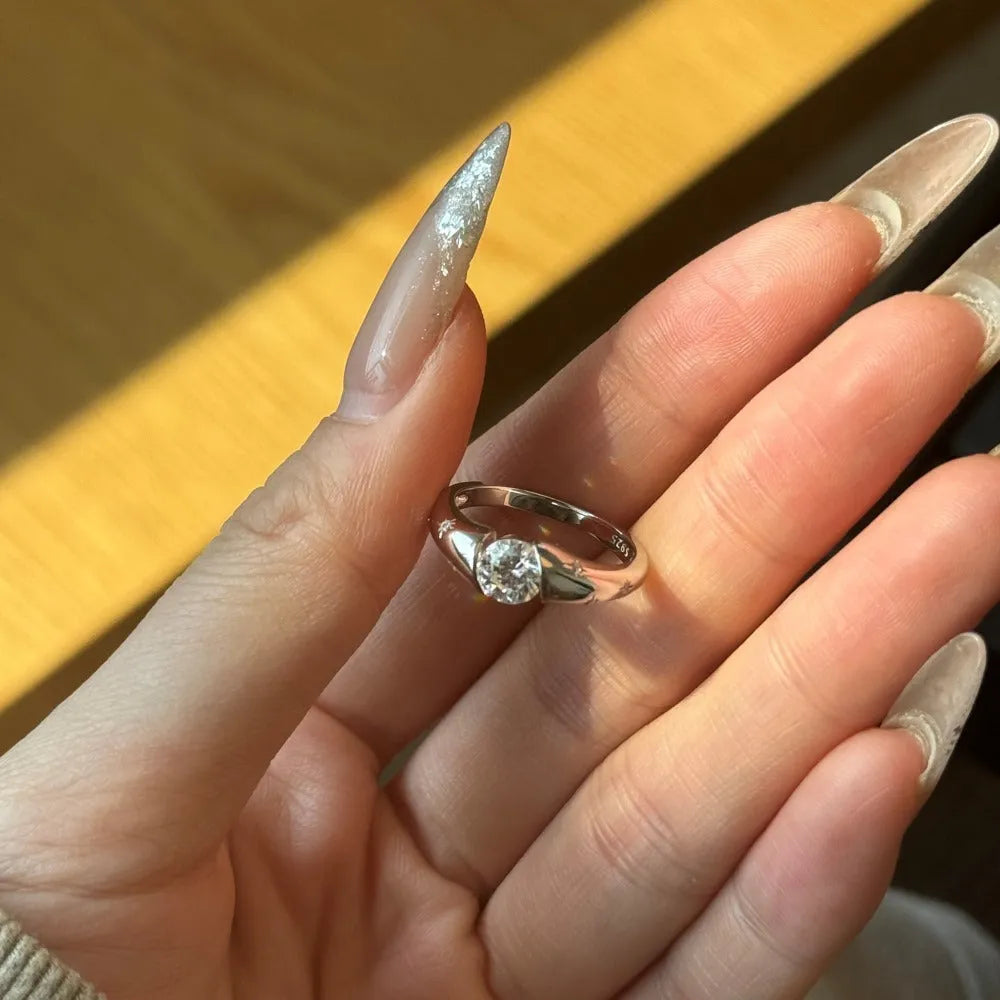 Silver round ring with glossy electroplated finish on display