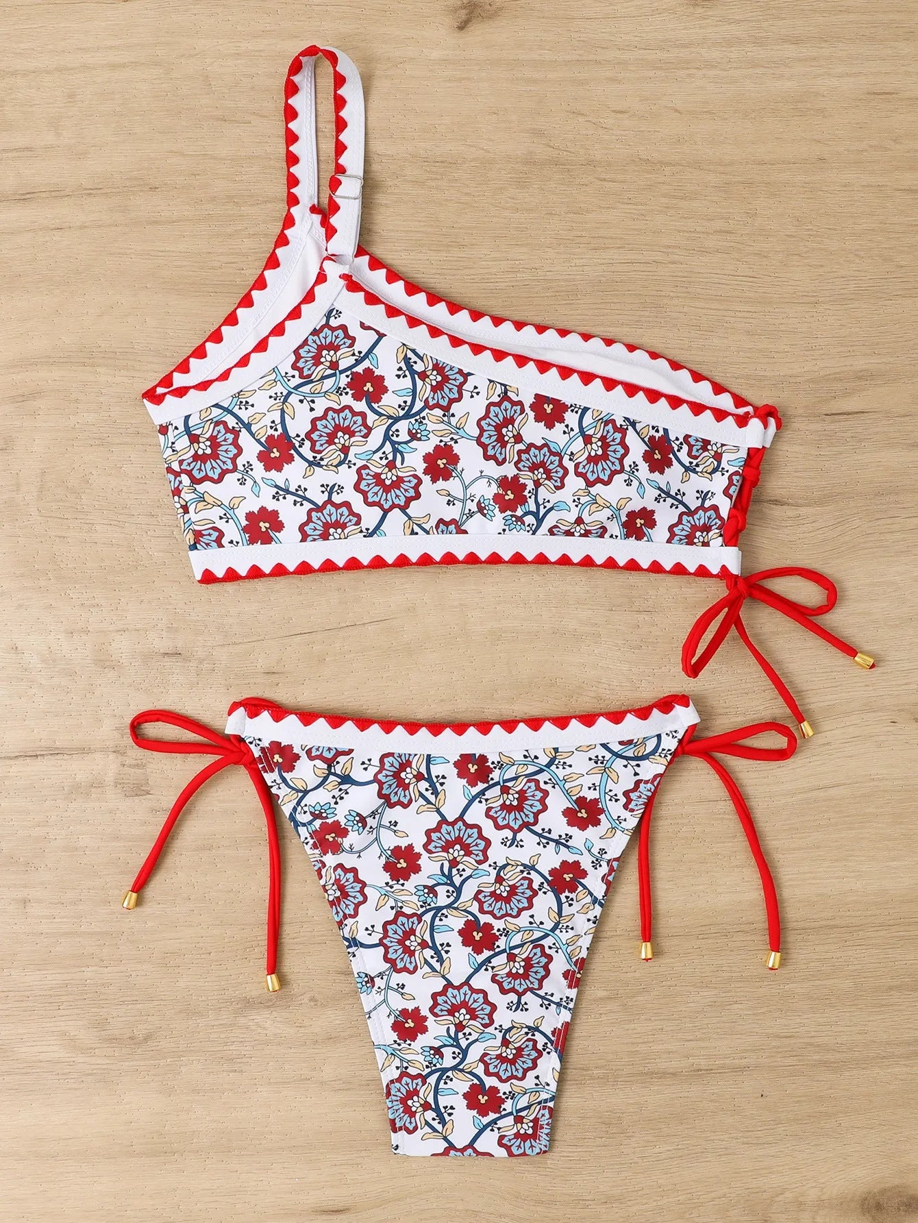 Blue one-shoulder women's floral bikini set with brief bottoms on mannequin