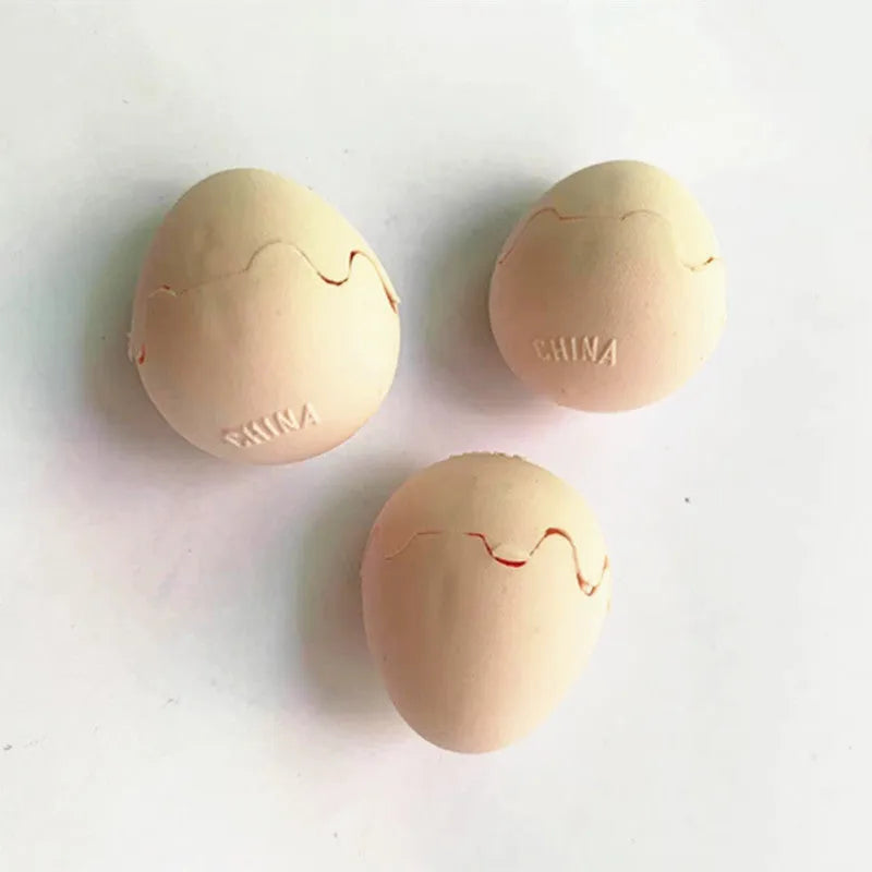 Fake snake egg prank toy with plastic egg shell and stretchable snake on plain background