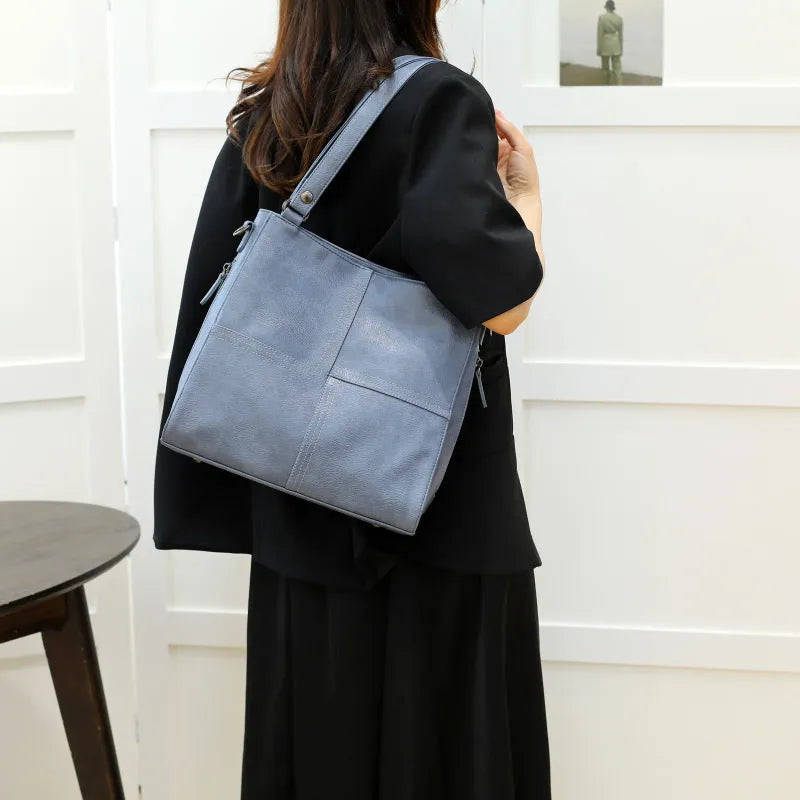 Barrel-shaped crossbody handbag in soft PU leather measuring 30 by 31.5 centimetres