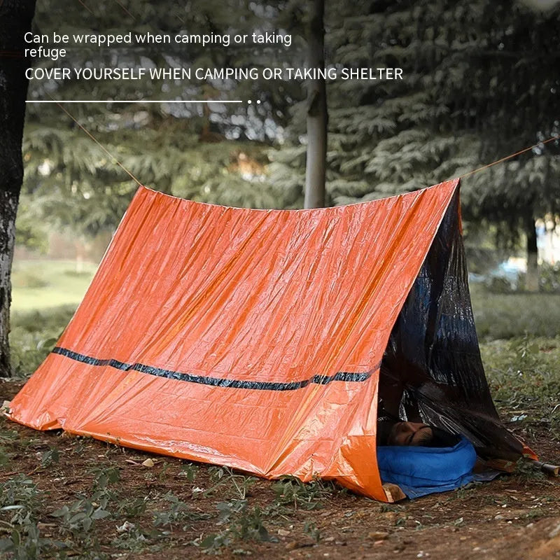 Orange disaster relief tent with sleeping bag and raincoat emergency package