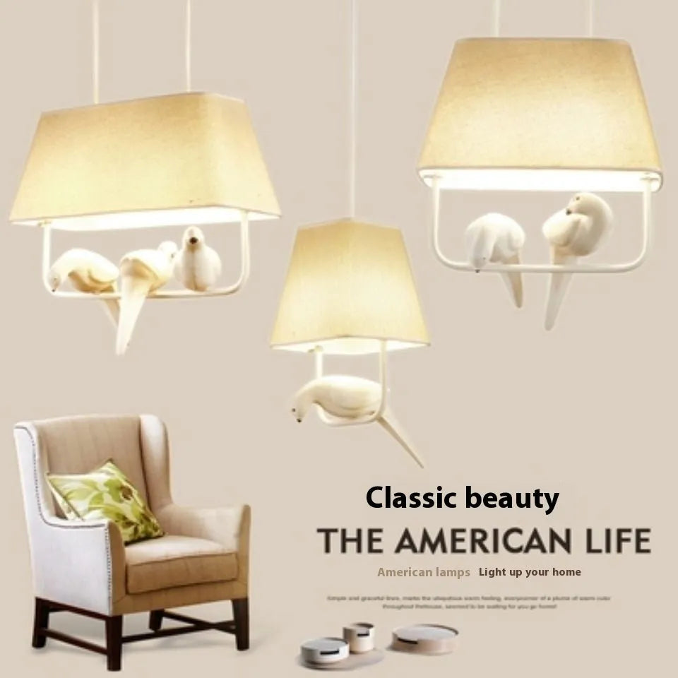 Bird chandelier ceiling lamp with iron frame and fabric shade in dining room setting