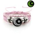 Luminous sun and moon couple leather bracelet on black background, showing glass pattern and adjustable chain