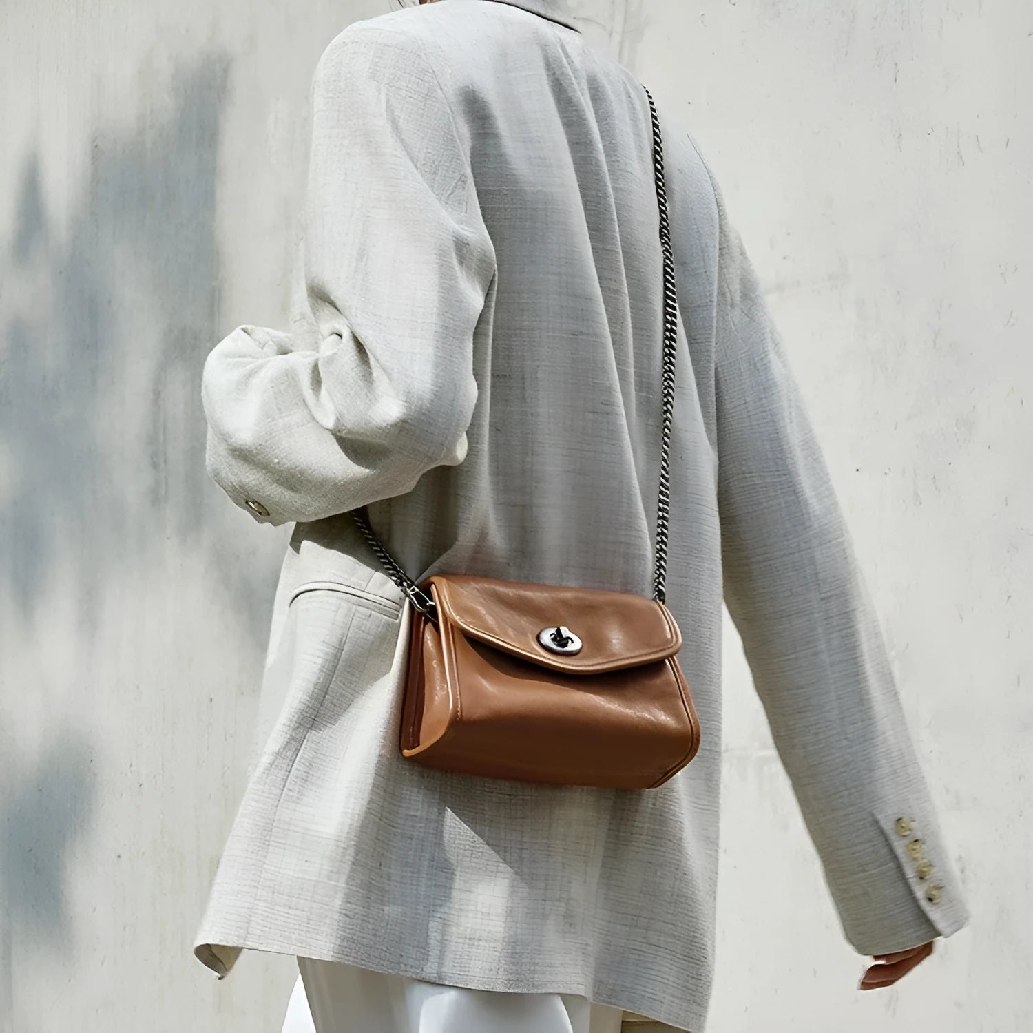 Small genuine leather messenger bag in Black with envelope flap and single shoulder strap