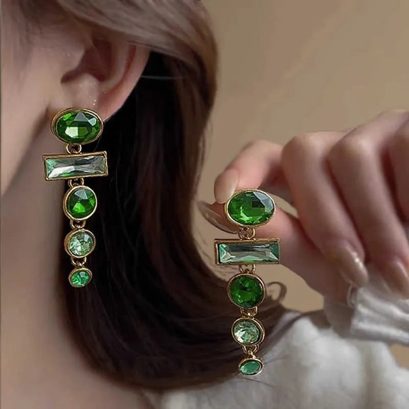 A pair of retro green gradient alloy earrings with geometric Chinese-style design, inlaid zircon stones, and decorative tassels.