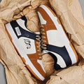 Pair of simple lace-up fashion sneakers on a white background