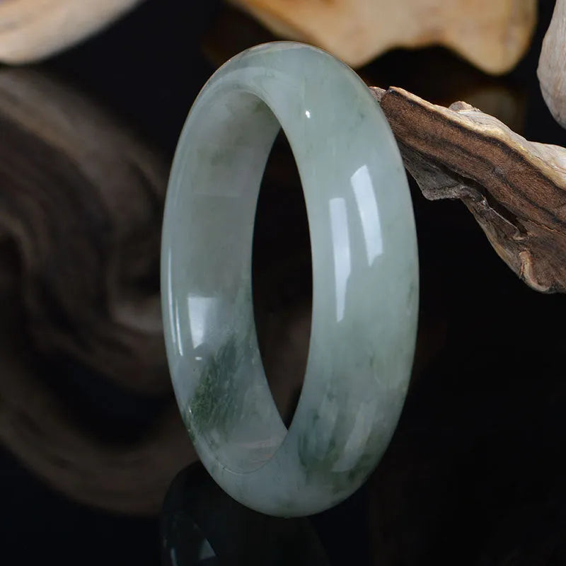 Natural Tianshan Jinsi Jade Chinese style bracelet showing circular form on a plain background.