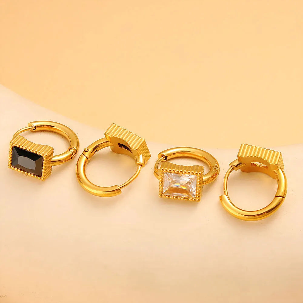 Square geometric stainless steel earrings with round ring details in white, black, or green.