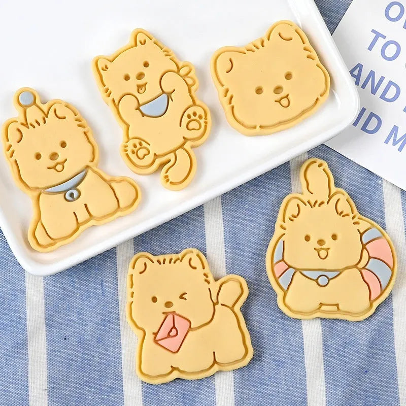 Plastic biscuit mould with puppy head designs including birthday hats and swimming rings