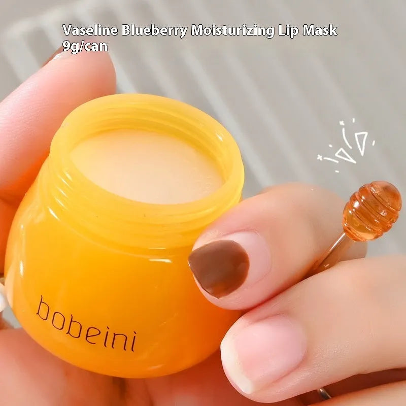 Vaseline lip balm in 9g honey pot with small brush applicator in pomegranate or blueberry flavour