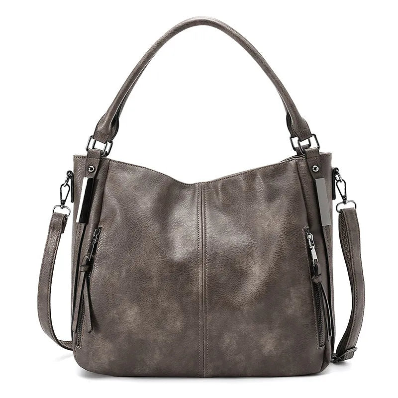 Soft PU crossbody shoulder bag in khaki with metal accent and double strap connectors on a white background