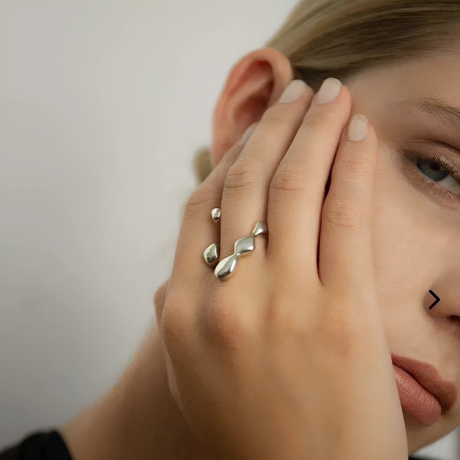 Gold and silver adjustable opening fashion ring with spherical design on a brass base.
