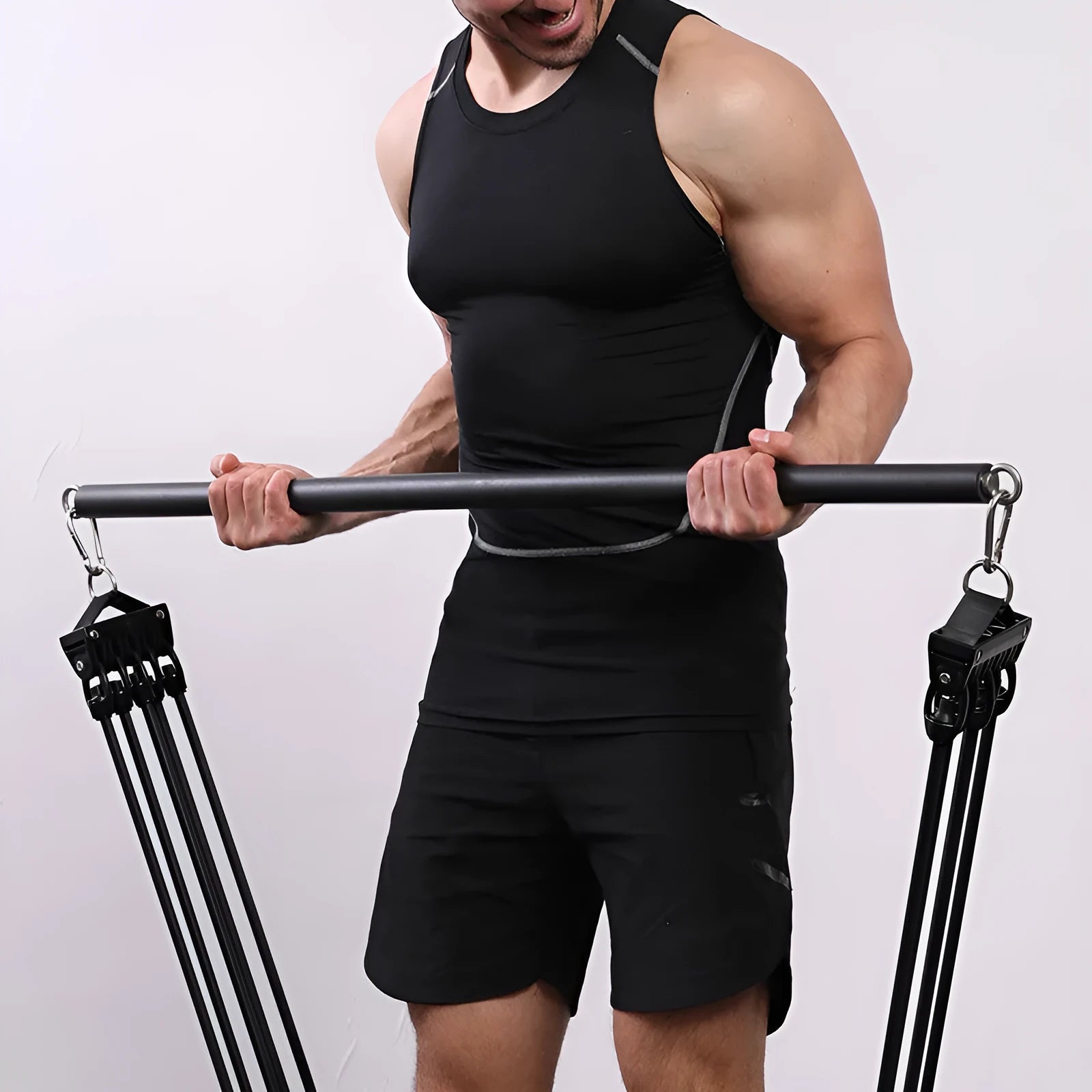 Stainless steel pilates stick with black EVA sponge grip and a silver bearing ring.