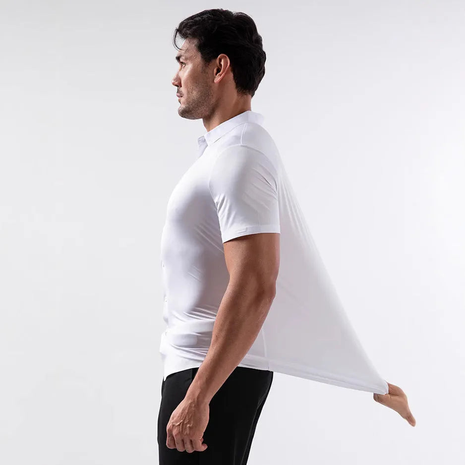 Man wearing a grey short sleeve cardigan-style shirt made from elastic non-iron fabric.
