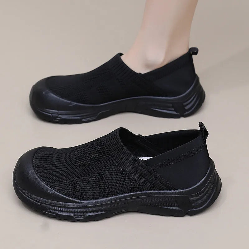 Women's black slip-on shoes with cloth upper and PVC sole in round-toe design