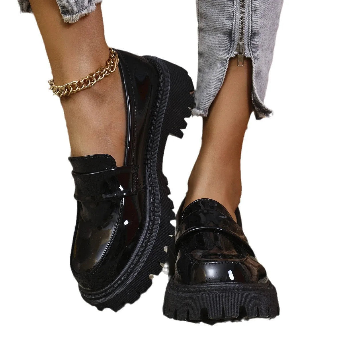 Women's plus size black slip-on loafers with a chunky platform heel and mid-top design.