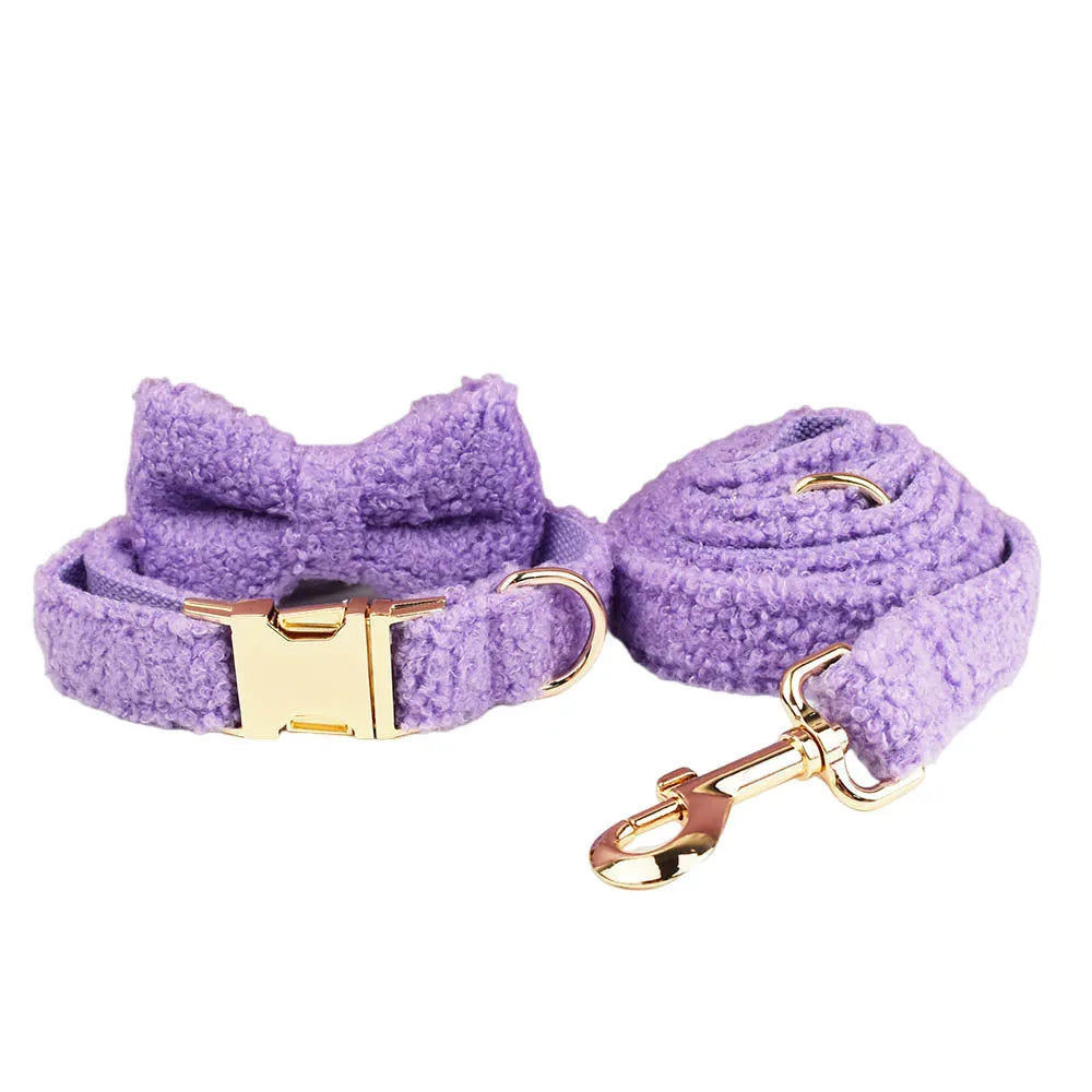 Purple cloth dog collar, lead, bow, and vest set laid out flat, showing the four matching accessories.