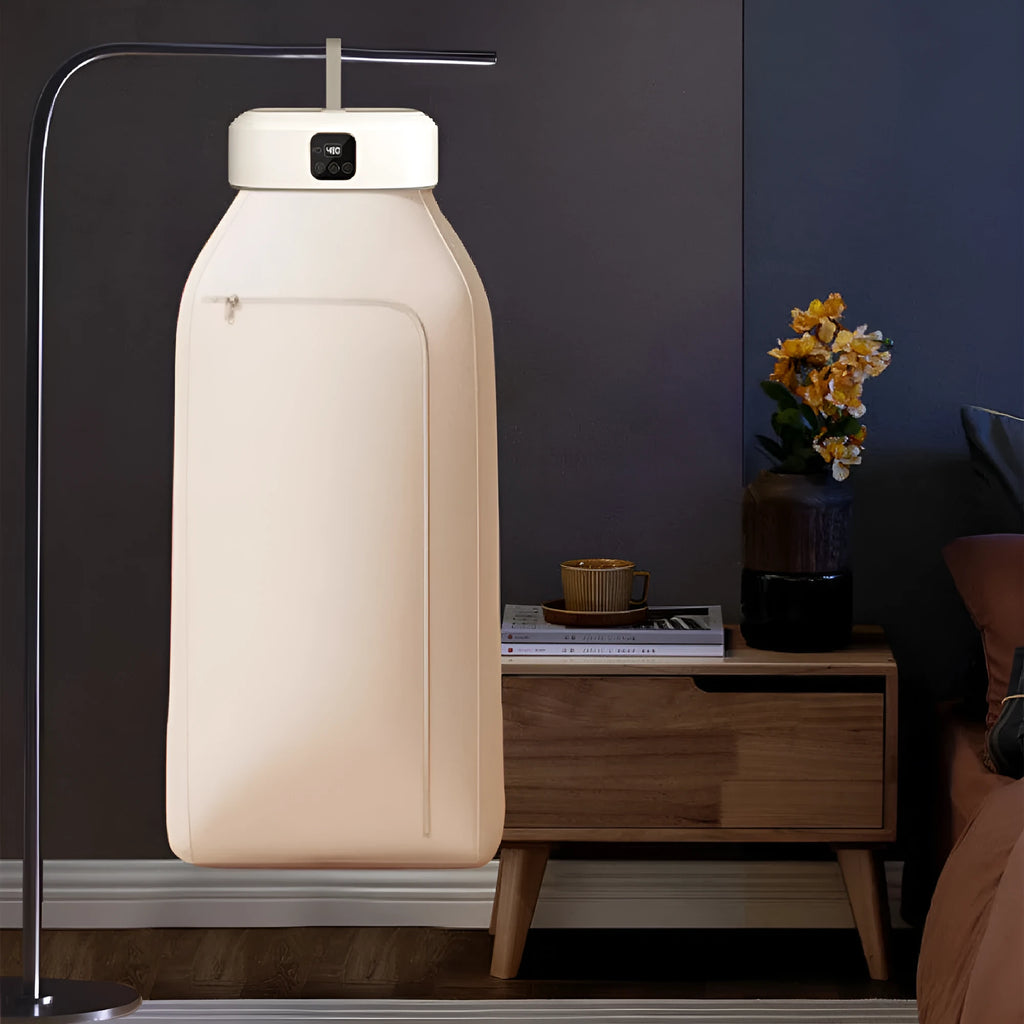 White cylindrical laundry dryer with remote control on countertop showing compact 29cm height