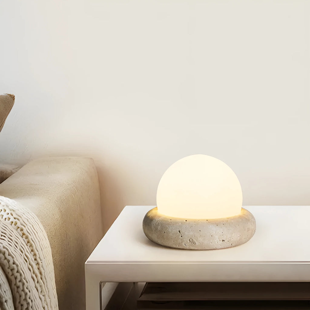 Cream coloured modern bedside night lamp with remote control on wooden table