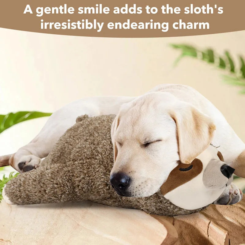 Sloth-coloured pet soothing plush toy with heartbeat device on soft surface