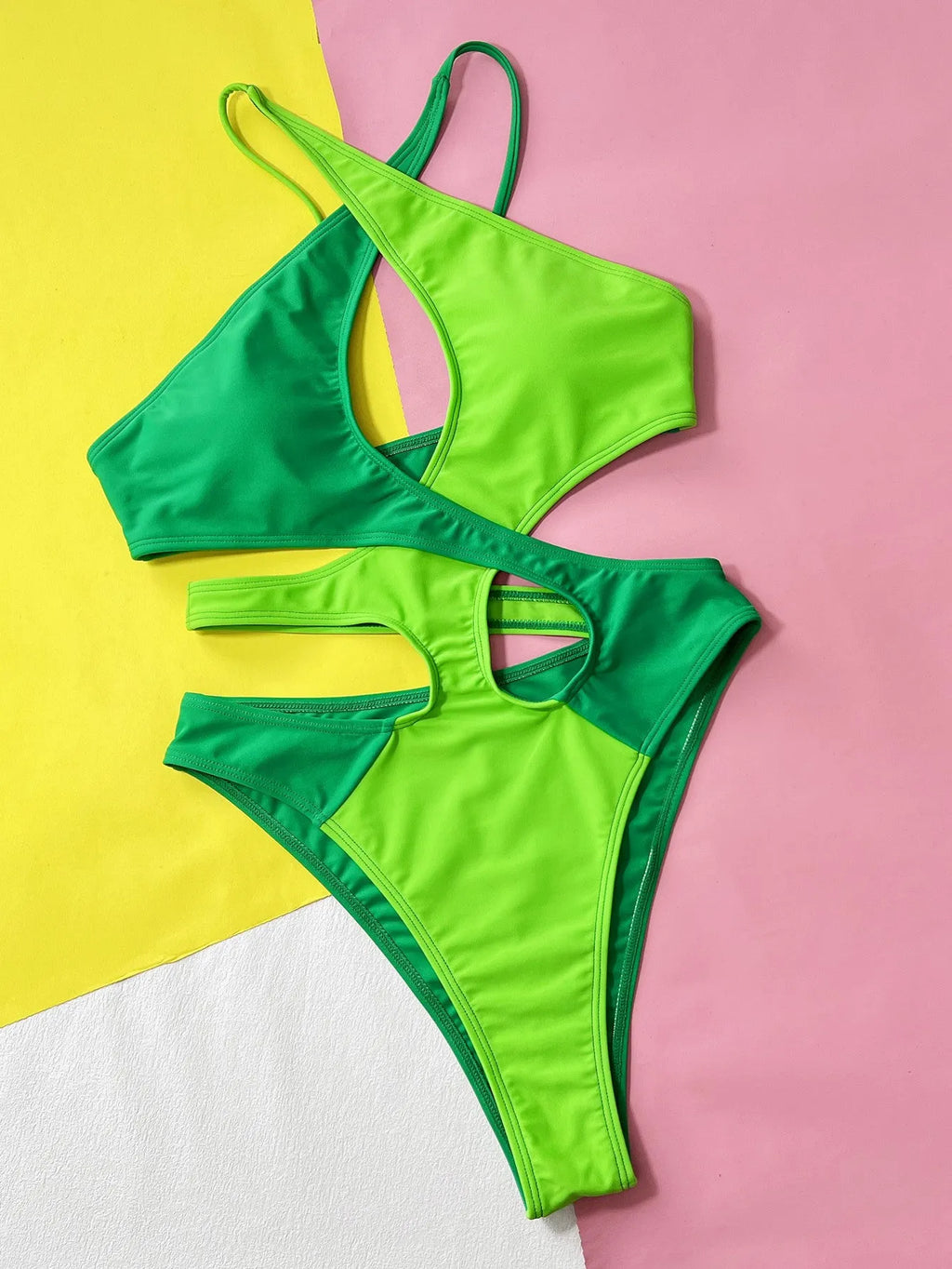 Green solid colour one-piece swimsuit for women with a hollow back, shown on a mannequin.