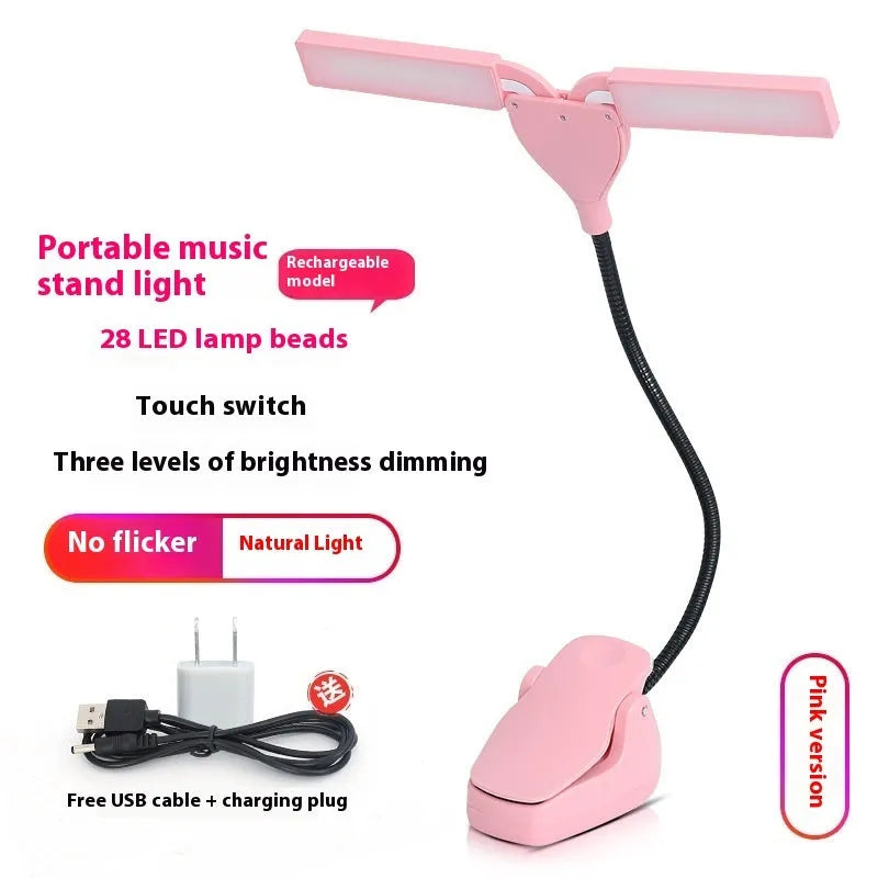 Black rechargeable music stand light with 28 LEDs and USB cable on a music stand.