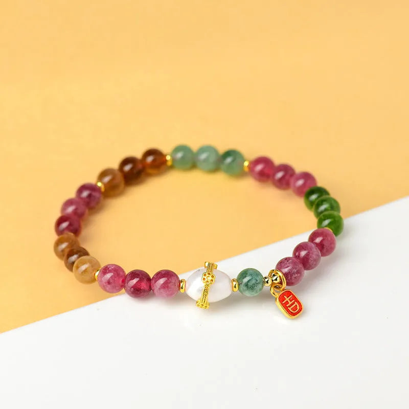 Geometric chalcedony crystal bracelet with 6.5mm beads on a wrist.