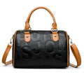 Brown cylindrical PU leather crossbody bag with three shoulder straps showing interior polyester lining