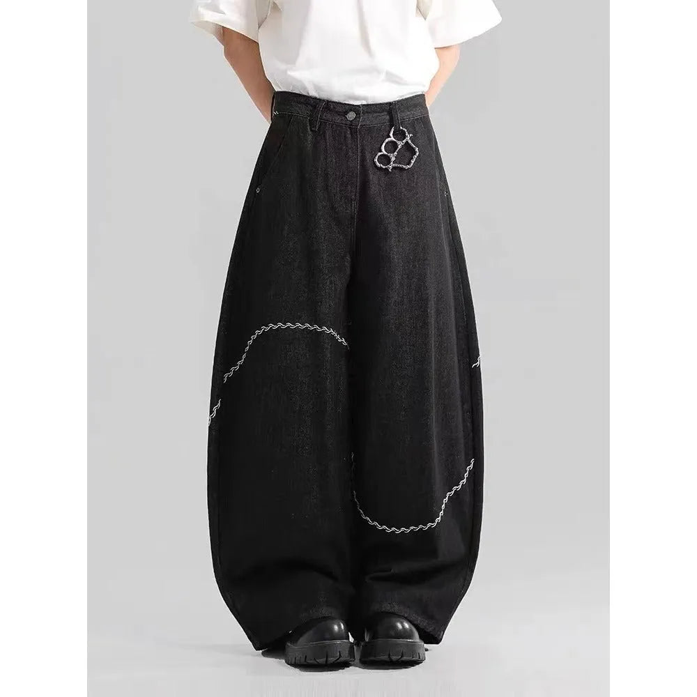 Black straight-leg denim trousers with a mid-waist fit and zip fly, laid flat.