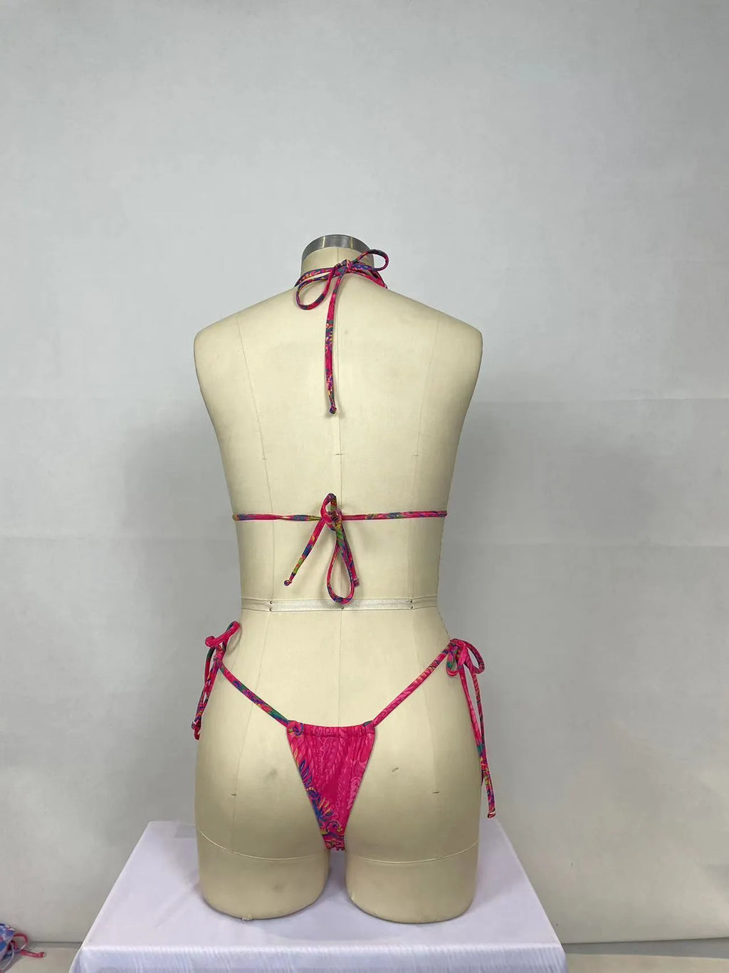 Women's pink nylon bikini two-piece set with sleeveless backless top and briefs bottom
