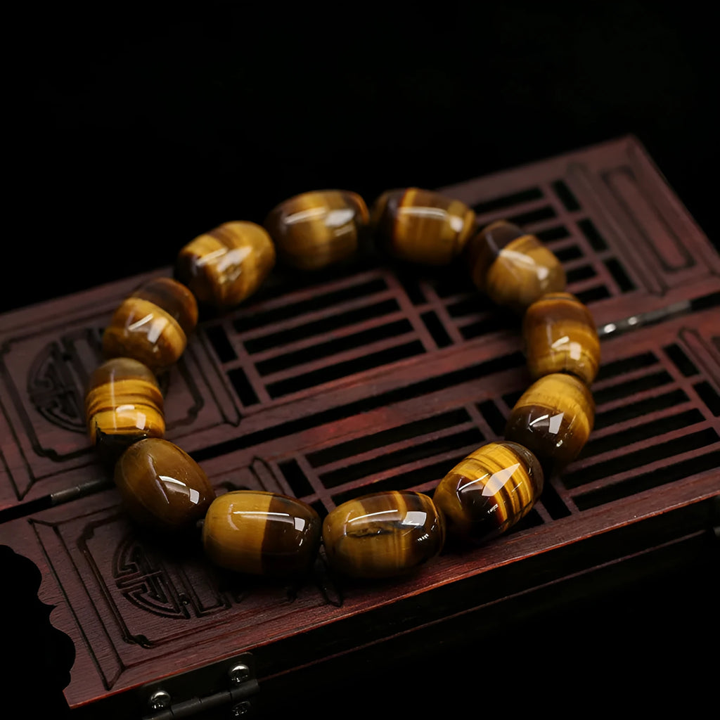 Yellow Tiger's Eye gemstone beaded bracelet with ethnic styling on a wrist.