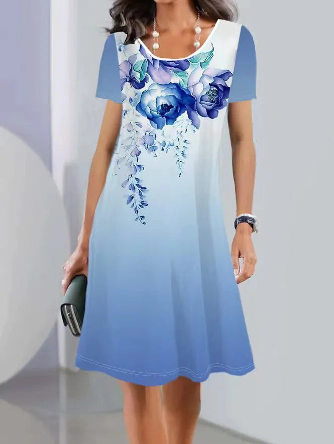 Light blue mid-length dress with white plants and flowers print, A-line skirt, and short sleeves.