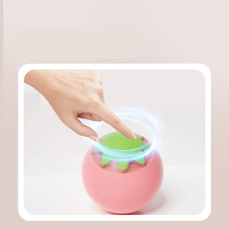 Green electric rolling ball pet toy for dogs and cats on a floor.